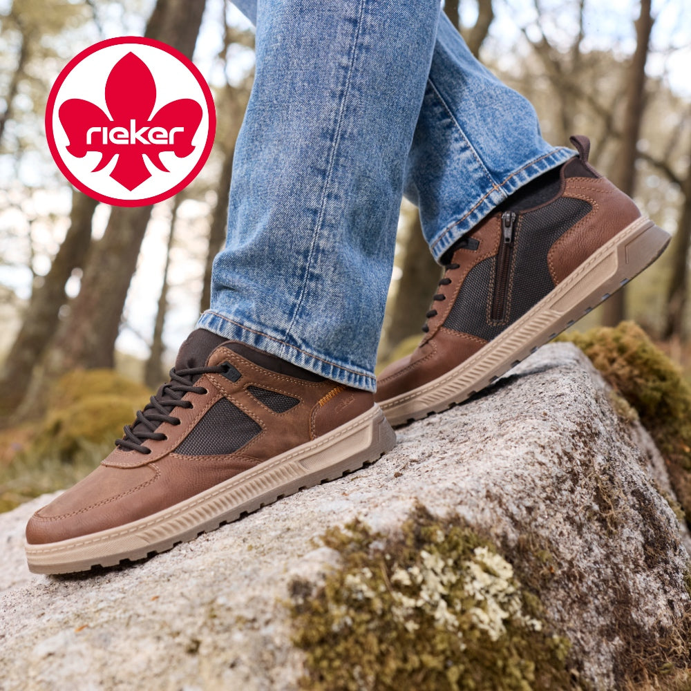 brown rieker trainers standing on a rock