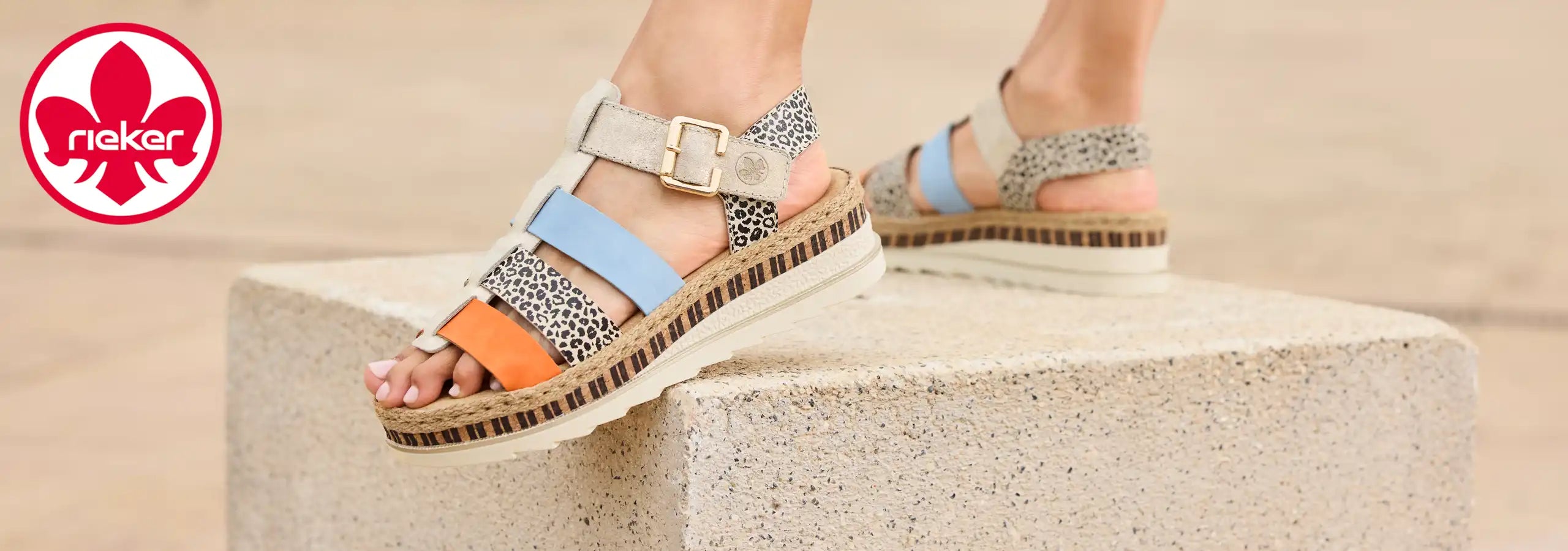 Colorful sandals with a brand logo in the corner on a beige background