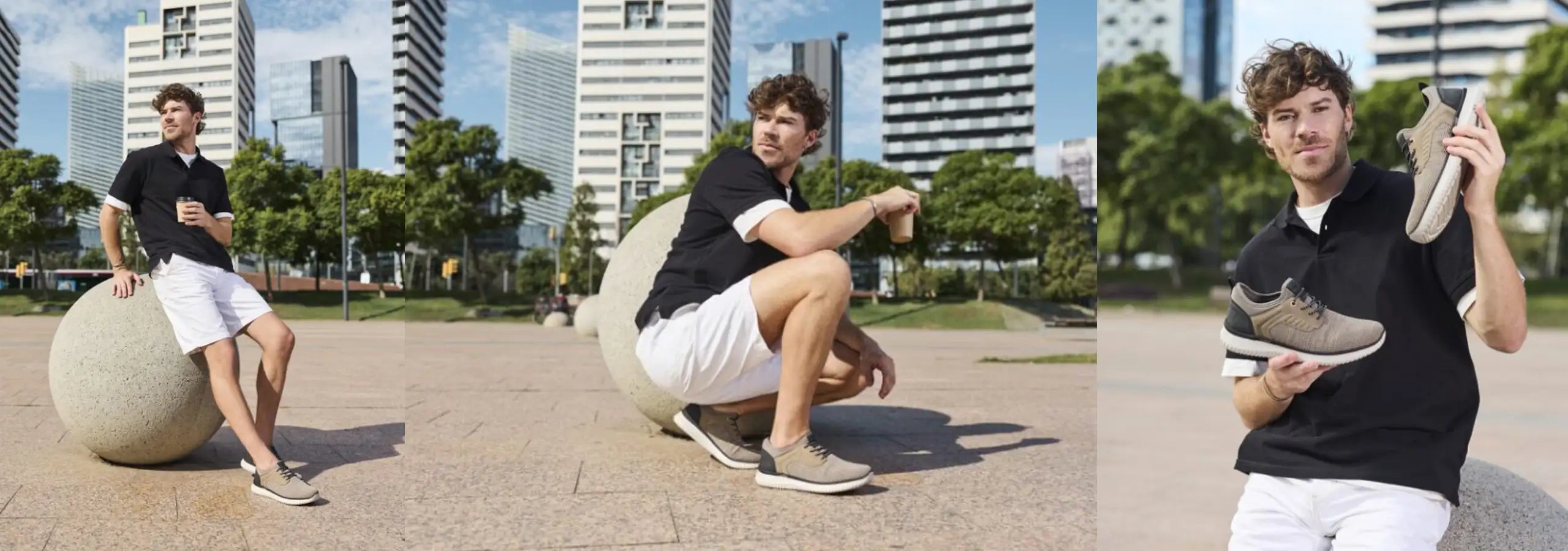 Man sitting on a stone sculpture, crouching, and holding shoes in an urban park setting.