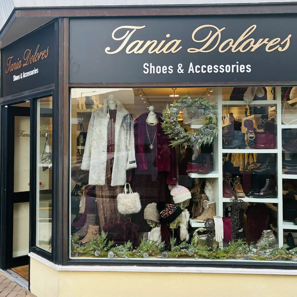 Tania Dolores Shoes & Accessories store front with mannequins and shoes displayed.